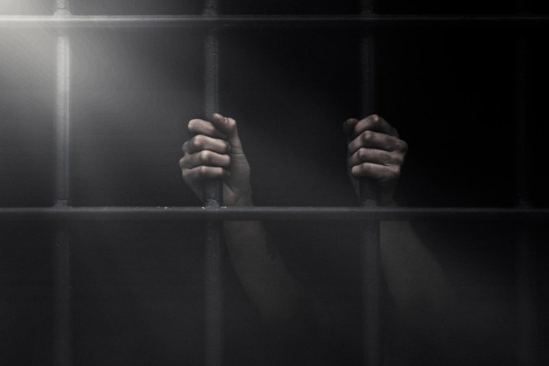 Тюремная решетка с руками