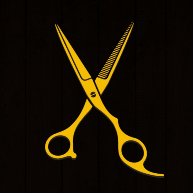 Золотые ножницы на сером фоне